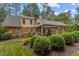 Expansive backyard view, with lush greenery, well-maintained landscaping, and a screened porch at 3919 Wentworth Dr, Durham, NC 27707