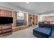 Finished basement featuring a cozy brick fireplace, built-in bookshelves and comfortable seating at 3919 Wentworth Dr, Durham, NC 27707