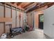Unfinished basement space with exposed beams, concrete floor, and access to the backyard at 3919 Wentworth Dr, Durham, NC 27707