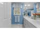 Bright blue bathroom with double vanity, large mirror, and well-lit space at 3919 Wentworth Dr, Durham, NC 27707