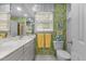 Bright bathroom featuring a double sink vanity and colorful wallpaper creating a cheerful space at 3919 Wentworth Dr, Durham, NC 27707