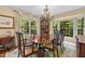 Elegant dining room with large windows and a chandelier at 3919 Wentworth Dr, Durham, NC 27707