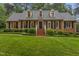 Charming brick home featuring a well-manicured lawn and dormer windows at 3919 Wentworth Dr, Durham, NC 27707