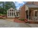Back exterior showcasing brick siding and siding, along with the patio and landscaped garden at 3919 Wentworth Dr, Durham, NC 27707