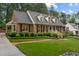 Brick home featuring landscaped grounds and mature trees at 3919 Wentworth Dr, Durham, NC 27707