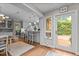 Bright kitchen featuring white cabinets, bar seating and a door to the backyard at 3919 Wentworth Dr, Durham, NC 27707