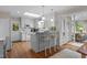 Bright kitchen featuring a breakfast bar, skylight, and white cabinets at 3919 Wentworth Dr, Durham, NC 27707