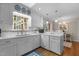 Bright kitchen featuring white cabinets, a window and modern appliances at 3919 Wentworth Dr, Durham, NC 27707