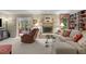 Comfortable living room with a fireplace, seating, and an open view to the sunroom at 3919 Wentworth Dr, Durham, NC 27707