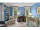 Cozy office with built-in bookshelves, a desk, and natural light from large windows at 3919 Wentworth Dr, Durham, NC 27707