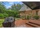 Charming brick patio with lush landscaping and a covered grill area, perfect for outdoor entertaining at 3919 Wentworth Dr, Durham, NC 27707