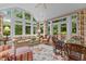 Bright sunroom with large windows, comfortable seating, and access to the outdoors at 3919 Wentworth Dr, Durham, NC 27707