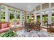 Inviting sunroom with many windows, comfortable seating, and access to a patio at 3919 Wentworth Dr, Durham, NC 27707