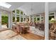 Bright sunroom with large windows, comfortable seating, and views of the backyard at 3919 Wentworth Dr, Durham, NC 27707