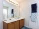Bright bathroom featuring a double sink vanity with white countertops and wood cabinets at 4234 Offshore Dr, Raleigh, NC 27610