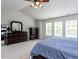 Bedroom featuring neutral carpet, bright natural light, and elegant, dark wood furnishings at 4234 Offshore Dr, Raleigh, NC 27610