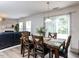 A dining area featuring a table set with decor, sliding glass doors and wood flooring at 4234 Offshore Dr, Raleigh, NC 27610