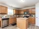 Well-lit kitchen with wood cabinets, stainless steel appliances, and a functional center island for food preparation at 4234 Offshore Dr, Raleigh, NC 27610