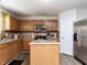 Functional kitchen featuring wooden cabinets, stainless steel appliances, and a convenient island with ample counter space at 4234 Offshore Dr, Raleigh, NC 27610