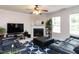 A cozy living room with a fireplace, TV, leather seating, and a blue patterned rug at 4234 Offshore Dr, Raleigh, NC 27610