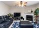A cozy living room with a fireplace, TV, leather seating, and a blue patterned rug at 4234 Offshore Dr, Raleigh, NC 27610