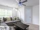 Living room with sectional couch, modern lamp, and ceiling fan at 4234 Offshore Dr, Raleigh, NC 27610