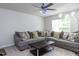 Spacious living room with a comfortable gray couch, throw pillows and dark wood coffee table at 4234 Offshore Dr, Raleigh, NC 27610