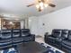 A large living room with leather seating, with an open view into the kitchen area at 4234 Offshore Dr, Raleigh, NC 27610