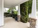 Inviting covered porch with stone columns and decorative plants, creating a cozy outdoor space at 4234 Offshore Dr, Raleigh, NC 27610
