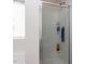 Shower features tiled walls, showerhead, and built-in shelving at 4234 Offshore Dr, Raleigh, NC 27610