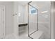 Elegant bathroom with glass shower, vanity area, and marble-style tile, creating a spa-like experience at 425 Edison Rail Ln, Knightdale, NC 27545