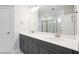 Bathroom features a double sink vanity with modern fixtures, a large mirror, and a glass enclosed shower at 425 Edison Rail Ln, Knightdale, NC 27545