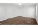 Bright bedroom features wood flooring, neutral walls, ceiling fan, and multiple doors for easy access at 425 Edison Rail Ln, Knightdale, NC 27545