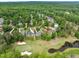 Aerial view of homes surrounded by a verdant golf course and tree-lined neighborhood at 498 Mountain Laurel, Chapel Hill, NC 27517
