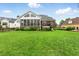 Expansive backyard with lush green lawn and inviting screened-in porch perfect for outdoor relaxation at 498 Mountain Laurel, Chapel Hill, NC 27517