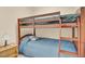 Cozy bedroom with a wooden bunk bed, ladder access to the top bunk, and warm lighting at 498 Mountain Laurel, Chapel Hill, NC 27517