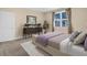 Well-lit bedroom with neutral walls, a decorative rug, and elegant furniture, plus a bright window at 498 Mountain Laurel, Chapel Hill, NC 27517