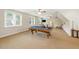 Spacious game room with a billiards table and ample natural light from multiple windows at 498 Mountain Laurel, Chapel Hill, NC 27517