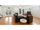 Bright living room with hardwood floors, fireplace, neutral color scheme, and access to a screened porch at 498 Mountain Laurel, Chapel Hill, NC 27517
