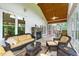 Relaxing screened porch with stone fireplace, comfortable seating, and natural light at 498 Mountain Laurel, Chapel Hill, NC 27517