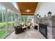 Inviting screened porch with stone fireplace and comfortable seating area at 498 Mountain Laurel, Chapel Hill, NC 27517