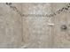 Shower with tile surround, built-in seat, and decorative accent tiles at 498 Mountain Laurel, Chapel Hill, NC 27517
