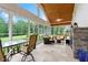 Spacious sunroom with a tile floor, vaulted ceiling, fireplace, and plenty of seating with backyard views at 498 Mountain Laurel, Chapel Hill, NC 27517