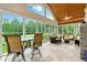 Sunroom with floor to ceiling windows, tiled floor, ceiling fan, and comfortable seating at 498 Mountain Laurel, Chapel Hill, NC 27517