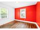 Bright bedroom with hardwood floors, painted accent wall and a window providing natural light at 504 Delaware Ave, Burlington, NC 27217