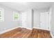 Bedroom with hardwood floors, painted walls, and a window providing natural light and ventilation at 504 Delaware Ave, Burlington, NC 27217