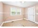 An empty eat-in kitchen provides natural light through its window and a white trimmed door, ideal for gatherings at 504 Delaware Ave, Burlington, NC 27217