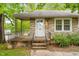 Inviting front porch with stone accents and iron railings, offering a glimpse into the cozy home at 504 Delaware Ave, Burlington, NC 27217
