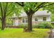 Charming single-story home with stone accents, a covered porch, and mature trees shading the front yard at 504 Delaware Ave, Burlington, NC 27217