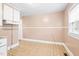 A blank eat-in kitchen area with neutral walls and flooring, offering a versatile space for various layout options at 504 Delaware Ave, Burlington, NC 27217